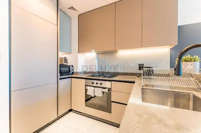 a kitchen with white cabinets and a stove at Burj Khalifa and Dubai Canal Views, Minutes from Downtown Dubai, Convenient Metro Access - 15 Northside Tower 2, Business Bay by Deluxe Holiday Homes in Dubai