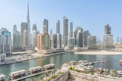 a view of a city with a river and buildings at Burj Khalifa and Dubai Canal Views, Minutes from Downtown Dubai, Convenient Metro Access - 15 Northside Tower 2, Business Bay by Deluxe Holiday Homes in Dubai
