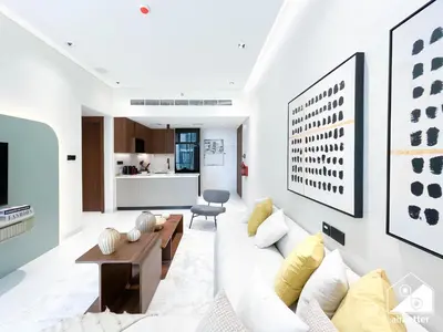 a living room with a couch and a table at Spacious 1-BR with Balcony & Leisure Facilities in Dubai