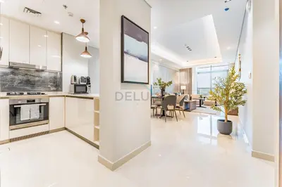 a rendering of a kitchen and dining room in a apartment at Spacious High-Floor 2BR with Stunning City and Burj Khalifa Views, Quick Drive to Downtown, and Steps from the Bus Station, Nobles, Business Bay by Deluxe Holiday Homes in Dubai