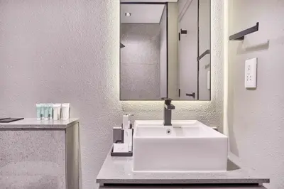 a bathroom with a white sink and a mirror at New Studio Apartment, MAG 910 - Dubai Stay in Dubai