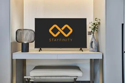 a desk with a computer on top of it at New Studio Apartment, MAG 910 - Dubai Stay in Dubai