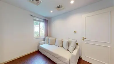 a white couch in a room with a window at Vacationer l Family Villa with Private Pool, Private Garden in Dubai