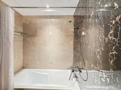 a bathroom with a shower with a bath tub at Stylish Studio in Elite Downtown in Dubai