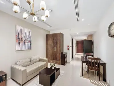 a living room with a couch and a table at Stylish Studio in Elite Downtown in Dubai