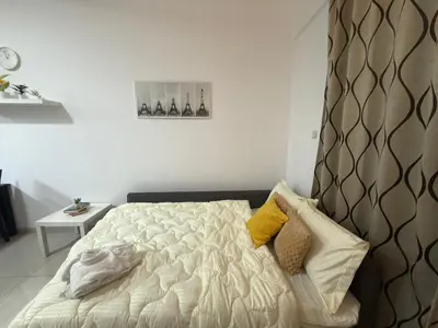 a bedroom with a bed and a table with a clock at Marina View Retreat 1BR In Escan Tower Marina in Dubai