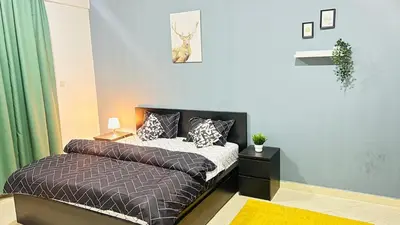 a bedroom with a bed and a green curtain at Marina View Retreat 1BR In Escan Tower Marina in Dubai