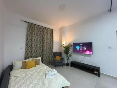 a bedroom with a bed and a flat screen tv at Marina View Retreat 1BR In Escan Tower Marina in Dubai