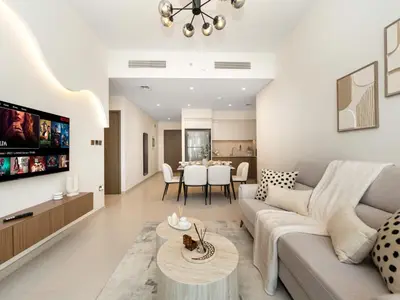 a living room with a couch and a table at Luxury 2BR- Pool with Burj View- 5 Min to Dubai Mall in Dubai