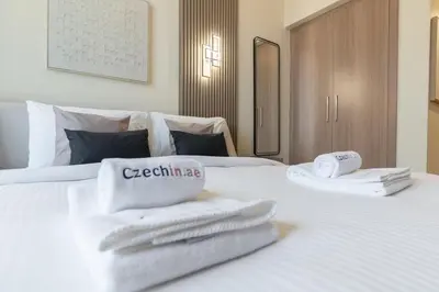 a hotel room with two white towels on a bed at Downtown-Close Studio by Czech-In in Dubai