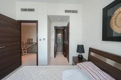 a bedroom with a bed and a hallway at Spacious Private 4-Bedroom Villa for Families & Groups in Dubai