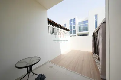 a hallway with a table and a chair in a building at Spacious Private 4-Bedroom Villa for Families & Groups in Dubai