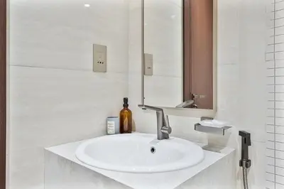 a bathroom with a white sink and a mirror at Relaxing 2BR in Business Bay Mins to Burj Khalifa in Dubai
