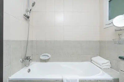 a bathroom with a white tub and a sink at Samaya Holiday Homes - Lake City Stunning Suits Lake View - Next to Metro in Dubai