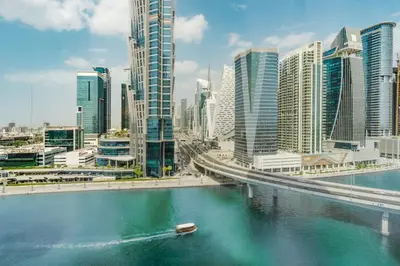 a river in a city with a bridge and buildings at RH Luxe Vibes 2BR Al Habtoor City, Mesmerizing Canal View in Dubai