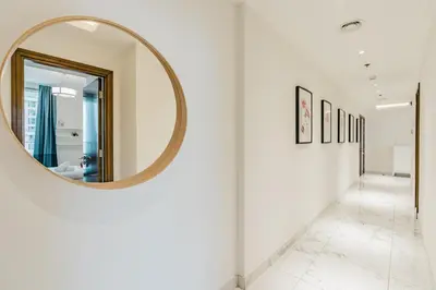 a hallway with a mirror on a wall at RH Luxe Vibes 2BR Al Habtoor City, Mesmerizing Canal View in Dubai