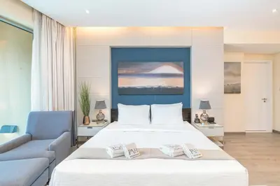 a bedroom with a large white bed and a couch at PVH - Emaar Residences - Burj Khalifa View Studio in Dubai