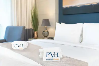 a hotel room with a bed with two towels on it at PVH - Emaar Residences - Burj Khalifa View Studio in Dubai