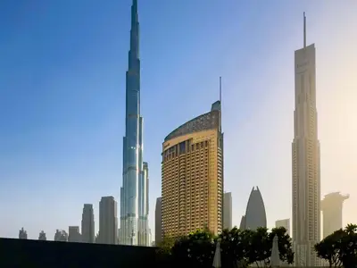 a group of tall buildings in a city at PVH - Dubai Mall Access 1BR - Emaar Fashion Avenue in Dubai
