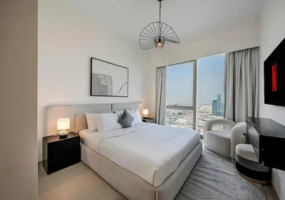 a hotel room with a bed and a large window at Iconic Burj Khalifa & Fountain Views, Luxury 2BR Downtown in Dubai