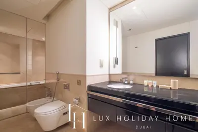 a bathroom with a toilet and a sink and a mirror at LUX The JW Marina Suite 4 in Dubai
