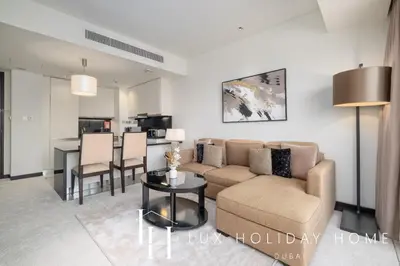 a living room with a couch and a table at LUX The JW Marina Suite 4 in Dubai