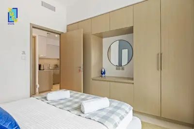 a bedroom with a large bed and a mirror at The Ivory Crown 1BR Downtown Dubai in Dubai