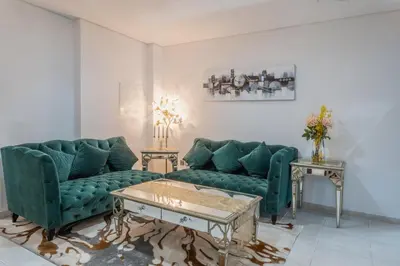 a living room with two green couches and a coffee table at 83rd Floor Luxurious Penthouse Full Sea View 6 BHK in Dubai
