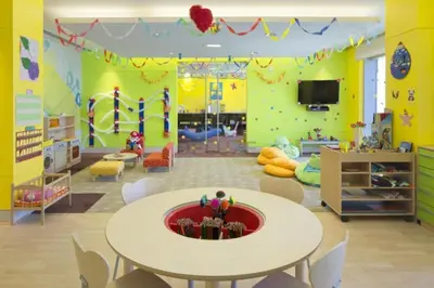 a childrens room with a table and a play area at Luxury 1BR with Breathtaking Dubai Water Canal Views, Just Beside Dubai Marina Mall and Tram, Near JBR Beach, The Address Residences, Dubai Marina by Deluxe Holiday Homes in Dubai