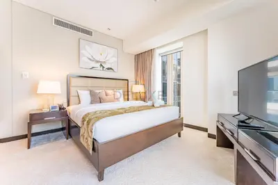 a bedroom with a bed and a flat screen tv at Luxury 1BR with Breathtaking Dubai Water Canal Views, Just Beside Dubai Marina Mall and Tram, Near JBR Beach, The Address Residences, Dubai Marina by Deluxe Holiday Homes in Dubai