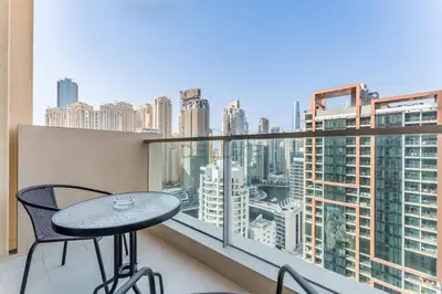 a table and chairs on a balcony with a view of a city at Luxury 1BR with Breathtaking Dubai Water Canal Views, Just Beside Dubai Marina Mall and Tram, Near JBR Beach, The Address Residences, Dubai Marina by Deluxe Holiday Homes in Dubai