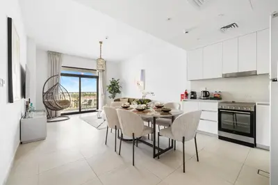 a kitchen and dining room with a table and chairs at Stylish 1BR with Balcony and Burj AlArab View in Dubai