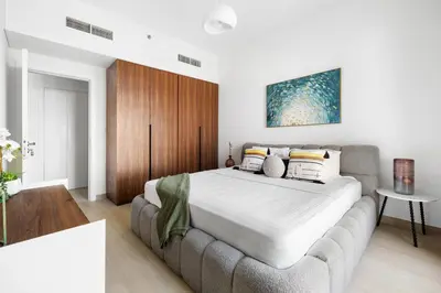 a bedroom with a large bed and a couch at Stylish 1BR with Balcony and Burj AlArab View in Dubai