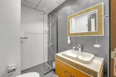 a bathroom with a sink and a mirror at Waves - Vibrant Studio, Perfect For Couples in Dubai