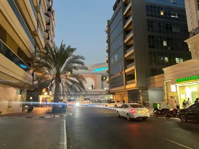 a city street with cars and a palm tree at Affordable Hostel in Al Barsha 1 Near Mall of Emirates Metro in Dubai