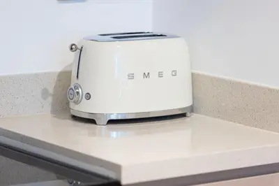 a toaster sitting on top of a counter at Moon Stays - Canal View- 2BR Missoni Stay in Dubai
