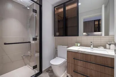 a bathroom with a toilet and a sink and a shower at New Studio in JVC - Hamilton House at 5th floor in Dubai