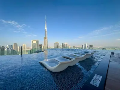 a row of boats in the water with a city at Paramount Towers & Residences - 1 Bedroom Apartment - Allsopp & Allsopp in Dubai