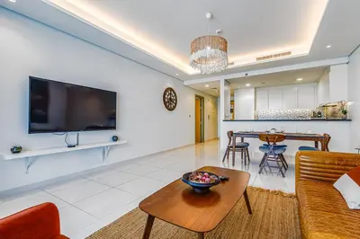 a living room with a couch and a table at Paramount Towers & Residences - 1 Bedroom Apartment - Allsopp & Allsopp in Dubai