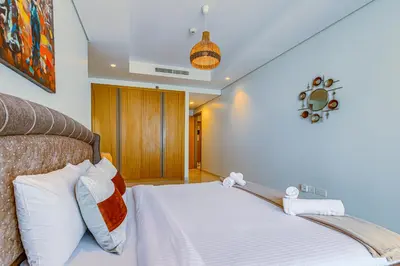 a bedroom with a bed with white sheets at Paramount Towers & Residences - 1 Bedroom Apartment - Allsopp & Allsopp in Dubai