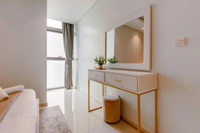 a bathroom with a sink and a mirror on a wall at Paramount Midtown - 1 Bedroom Apartment - Allsopp & Allsopp in Dubai