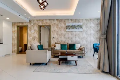 a living room with two couches and a table at Paramount Midtown - 1 Bedroom Apartment - Allsopp & Allsopp in Dubai