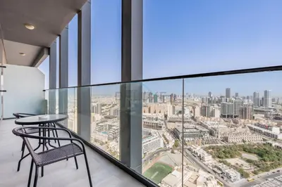 a glass balcony with a view of the city at Stay Near the Park with Easy Exit from JVC, Just Minutes to Dubai Marina and Palm Jumeirah - Bloom Towers A, JVC by Deluxe Holiday Homes in Dubai