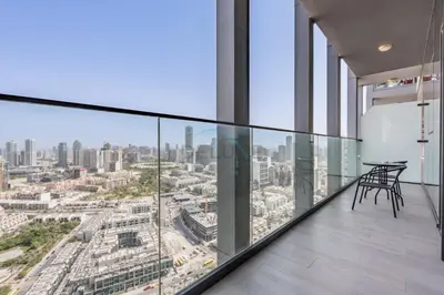 a glass balcony with a view of a city at Stay Near the Park with Easy Exit from JVC, Just Minutes to Dubai Marina and Palm Jumeirah - Bloom Towers A, JVC by Deluxe Holiday Homes in Dubai
