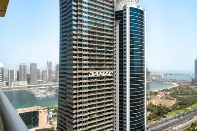 a large building with a sign on the side of it at Spacious 2BR Dubai Marina & City Views in Dubai