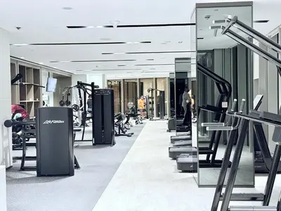 a gym with treadmills and machines in a building at Balcony Bliss 1BR with City View Pool & Gym in Dubai