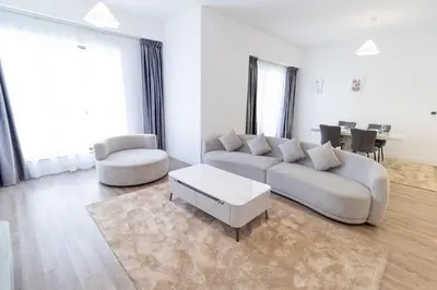 a living room with a couch and a table at Happy Season - Luxury Upgraded 2BR Rimal JBR in Dubai