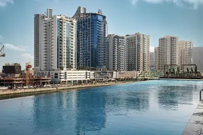 a river with tall buildings in the background at PNB Living - Luxury Studio with Canal Views - Trillionaire Residences, Business Bay in Dubai