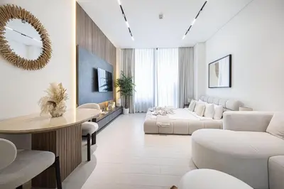 a living room with a couch and a table at PNB Living - Luxury Studio with Canal Views - Trillionaire Residences, Business Bay in Dubai