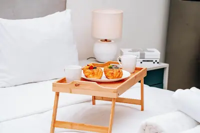a tray with a plate of food on a table at Skyline Views, Fully Equipped Studio with Balcony, Near Burj Khalifa in Dubai